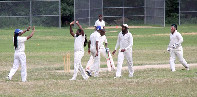 Gayle congratulated by teammates after claiming the wicket of Durrel Forrest.