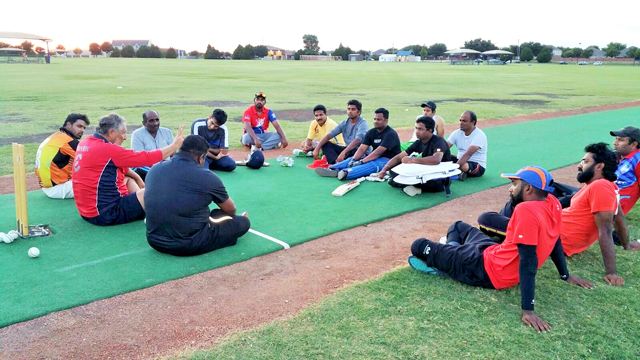 Fahad Shahnawaz (extreme left) listens to coach Mark Demos from Zimbabwe address Dallas Cricket League players set to participate in an inter-city tournament in Houston, TX. 