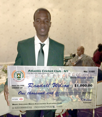 2016 Most Promising Player and Shevonne Mentis Educational Scholarship Fund recipient Randall Wilson cradles his $1,000.00 check.
