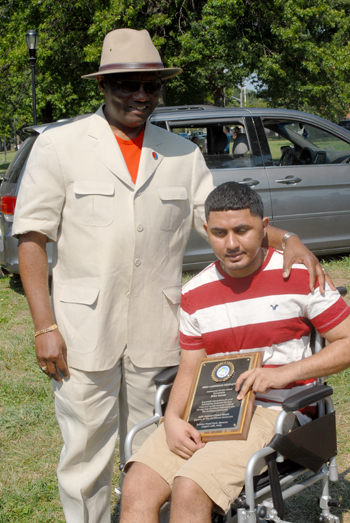 John Aaron one of the awardees at this years game with accident victim Ajay Teakram. Photo by Shem Rodney