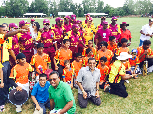 Queens United Youth Cricket Academy youngsters enjoy a photo op with the Windies Legends.