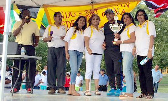 Cyril Choy Captain of the Caribbean Invitation team accepting the winning trophy from Executives of Federation, pictured from from left Carl Bennett, Ralph Tamesh, Shalini Hamid, Yvonne Singh, Sattie Sahadeow and Sabrina Dyal. 