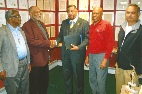 Michael Chambers, president of the Cricket Hall of Fame, second from left, presents Jamaican ambassador Ralph Thomas, center, with a certificate of appreciation during his recent visit to the institution. Looking on  is Ovid John, Treasurer, left, and Stanford Walker, Public Relations Director and Mahadeo Ajodhi, a committee member, right.