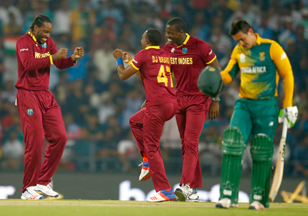 Chris Gayle and Dwayne Bravo dance to celebrate a South African wicket during their encounter. Photo by Christopher Lee-IDI/IDI via Getty Images