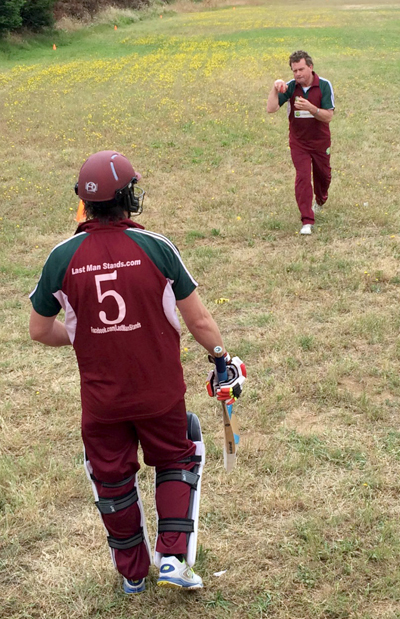 Martin Mackenzie (5) warms up ahead of his knock of 38 off 59 balls with Pete Carson giving him some throwdowns.
