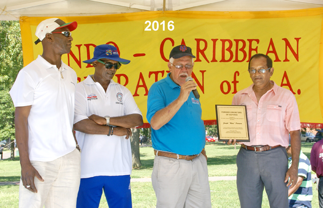 Reds Perriera accepting an award from Former Guyana national players, from left Ray Joseph, Sew Shivnarine and Tyronne Etwaroo.