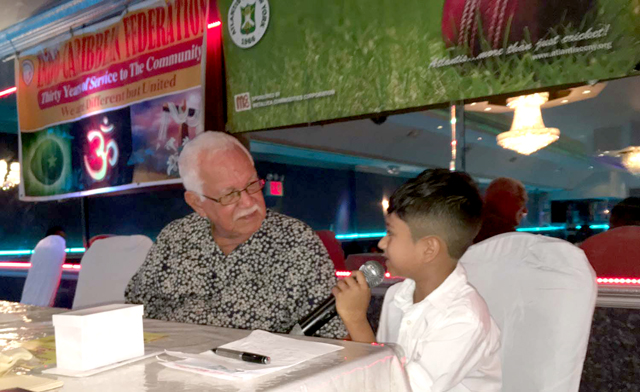 Reds Perreira (left) being interviewed by eight year-old Matthew Achaibar at Atlantis CC's 50th Anniversary "Gaffin' bout cricket wid Reds" event.