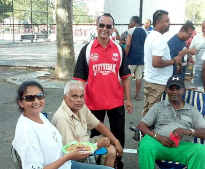Fans at the game, Dolly Prashad, Krish Prashad, Zaffie Mohamed and Sew Shivnarine. Pictured above is the victorious Atlantis team and supporters with championship trophy.